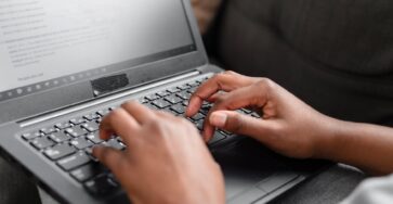 person using black and gray laptop computer